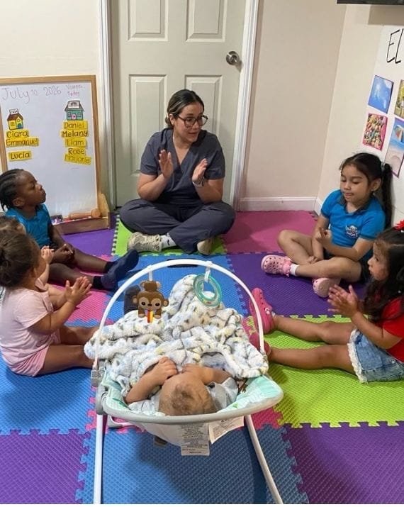 Teacher leading a group learning activity at Sweet Angels Daycare