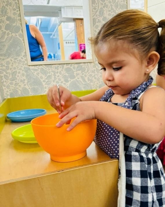 Child participating in a sensory learning activity at Sweet Angels Daycare