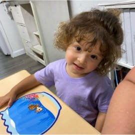 Child enjoying a classroom activity at Sweet Angels Daycare