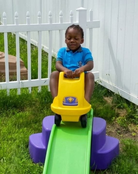 Child playing outdoors at Sweet Angels Daycare