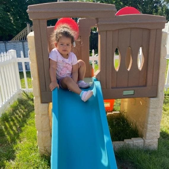 Infant enjoying outdoor play at Sweet Angels Daycare & Preschool Center