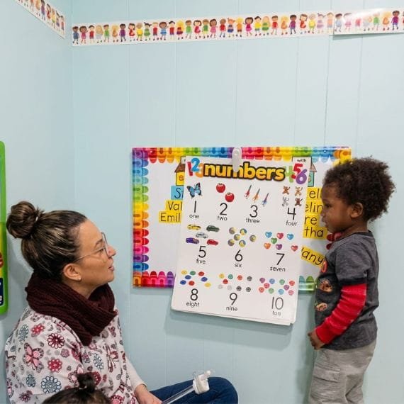 Children developing fine motor skills through a hands-on learning activity at Sweet Angels Daycare & Preschool Center