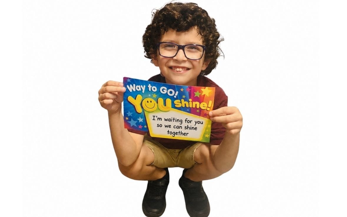 Child at Sweet Angels Daycare holding a positive learning message