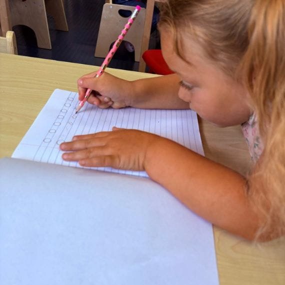 Toddler practicing pre-writing skills at Sweet Angels Daycare & Preschool Center