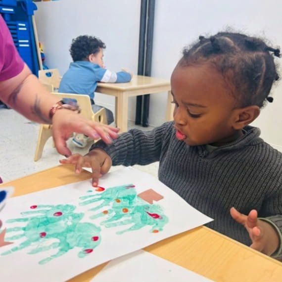 Child participating in an arts and crafts activity at Sweet Angels Daycare & Preschool Center