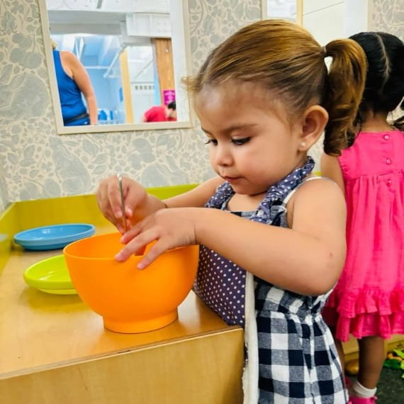 Child exploring a sensory play activity at Sweet Angels Daycare & Preschool Center