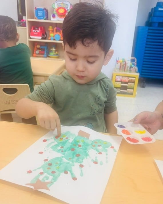Child painting during an art activity at Sweet Angels Daycare in Everett, MA