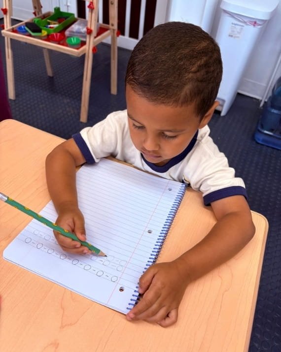Child practicing writing at Sweet Angels Daycare in Everett, MA